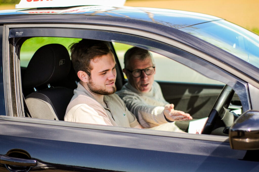 Learner driver with instructor inside a 5day vehicle